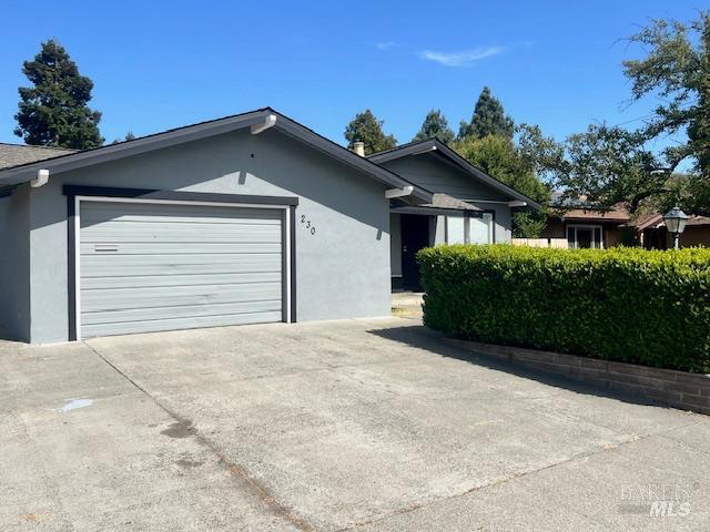 230 Lawrence St, Fairfield, CA 94533 - ranch-style house with stucco siding, an attached garage, and concrete driveway