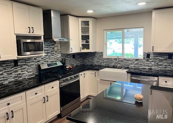 230 Lawrence St, Fairfield, CA 94533 - kitchen featuring stainless steel appliances, wall chimney exhaust hood, a sink, white cabinetry, and recessed lighting