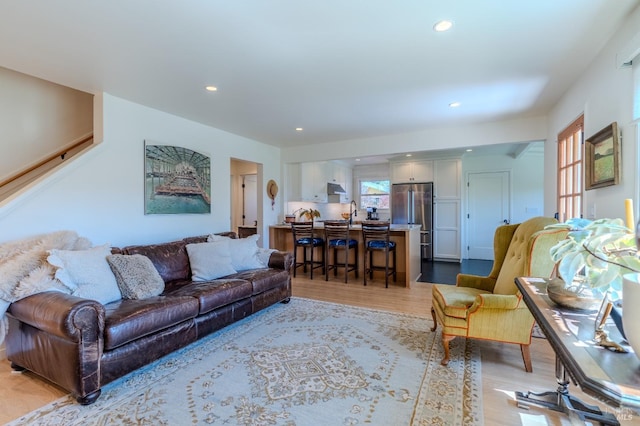 living area featuring light wood-style flooring and recessed lighting