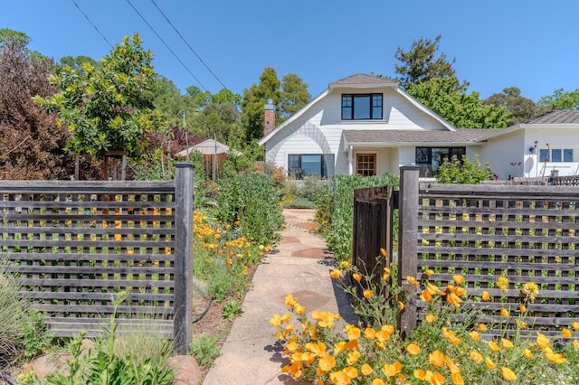 view of front of home with fence and a gate