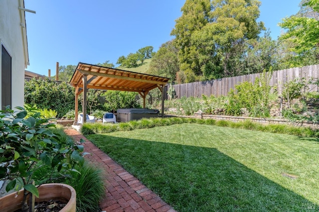 view of yard with a pergola, a fenced backyard, and a hot tub