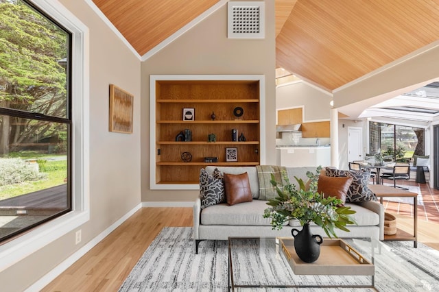 living area featuring visible vents, wooden ceiling, ornamental molding, and lofted ceiling