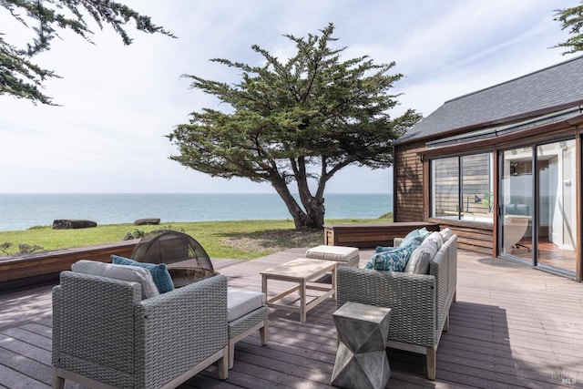 deck with an outdoor living space and a water view