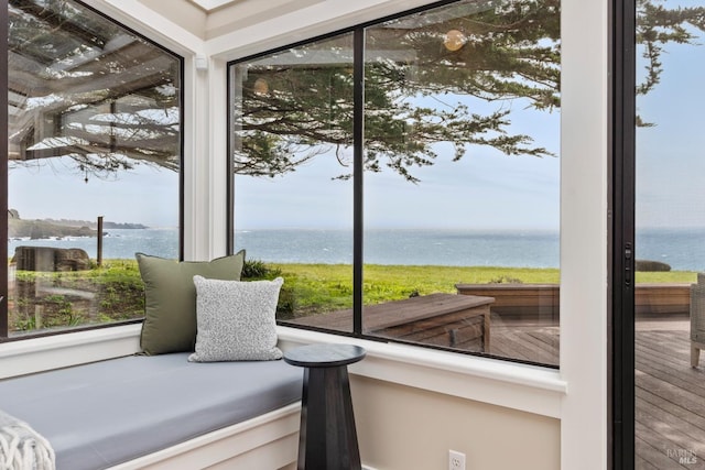 sunroom / solarium featuring a water view