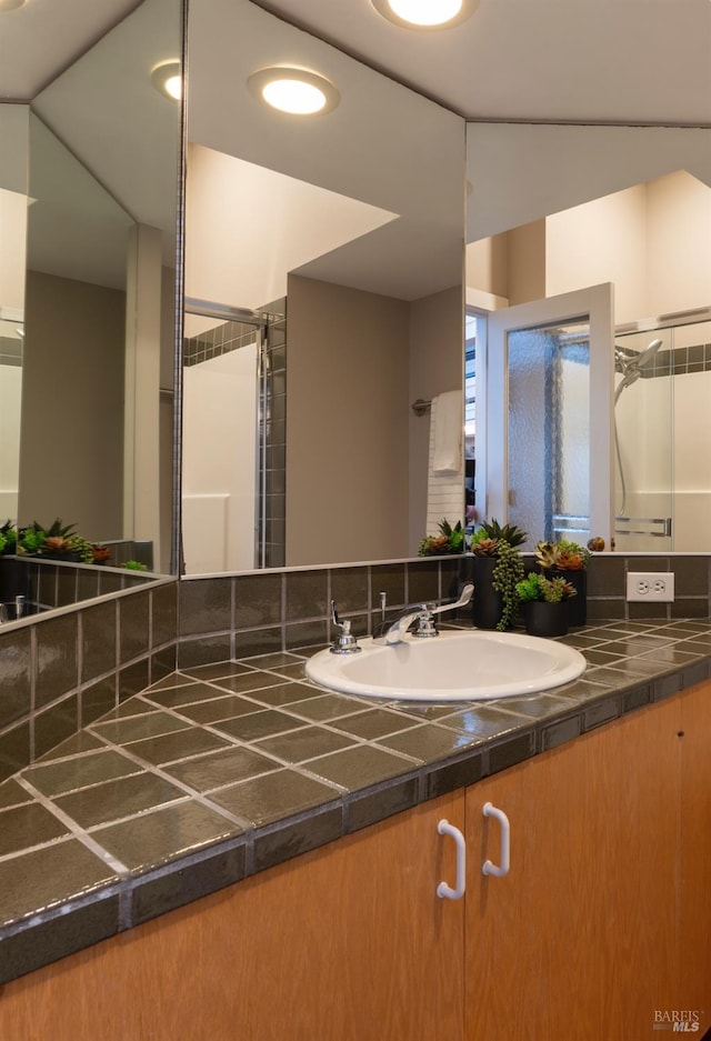 bathroom with a stall shower and vanity