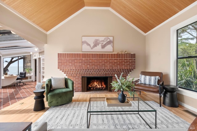 interior space featuring wooden ceiling, a fireplace, ornamental molding, and visible vents