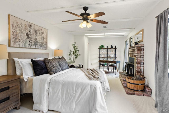 1009 Tilton Rd, Sebastopol, CA 95472 - bedroom with light colored carpet, ceiling fan, and a wood stove