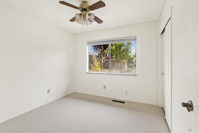 1009 Tilton Rd, Sebastopol, CA 95472 - unfurnished bedroom with light carpet, a textured ceiling, a closet, a ceiling fan, and baseboards