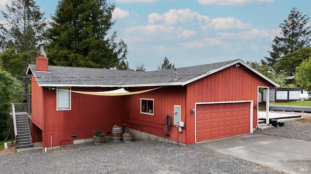 1009 Tilton Rd, Sebastopol, CA 95472 - view of property exterior featuring crawl space, a shingled roof, a garage, a chimney, and gravel driveway