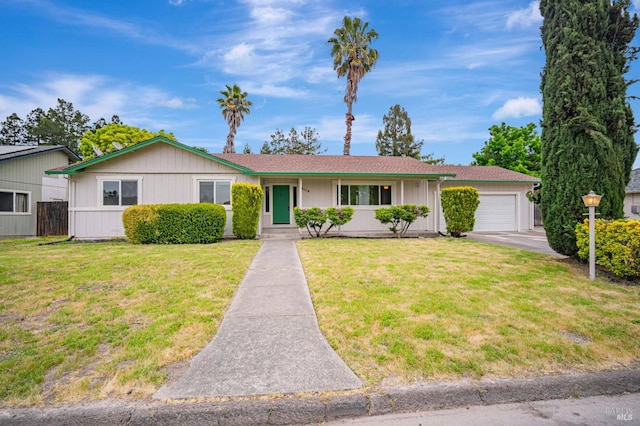 single story home featuring an attached garage, driveway, and a front yard