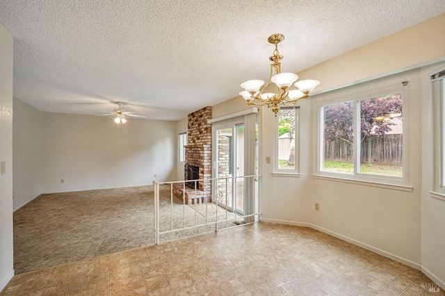 interior space featuring baseboards, a textured ceiling, stone finish flooring, and ceiling fan with notable chandelier