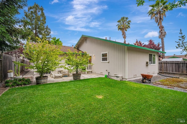 back of house with a lawn, a fenced backyard, and a patio area