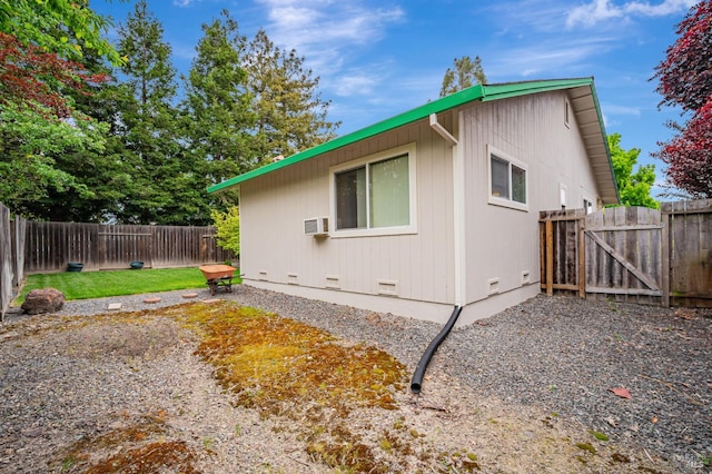 view of home's exterior with a fenced backyard, a gate, and crawl space