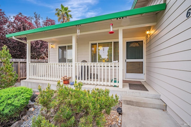 view of exterior entry featuring a porch