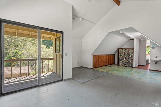 additional living space with high vaulted ceiling and baseboards