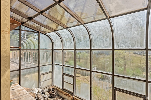 unfurnished sunroom with lofted ceiling