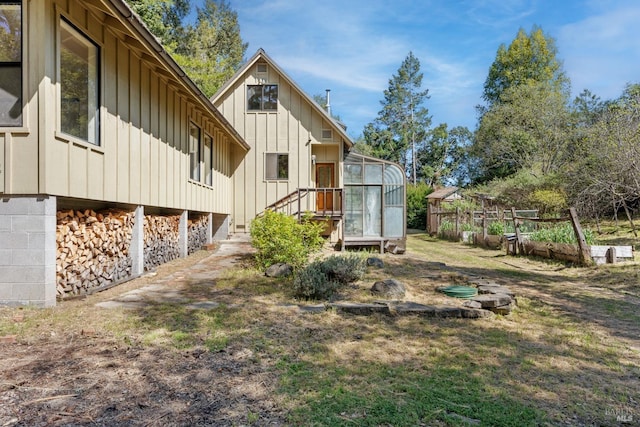 exterior space featuring board and batten siding and a vegetable garden