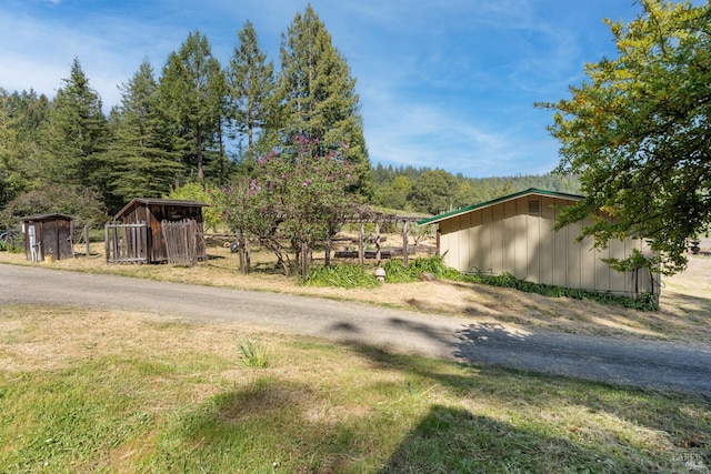 view of property exterior with an outdoor structure