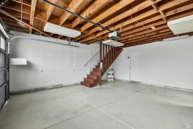 basement featuring a garage and stairs