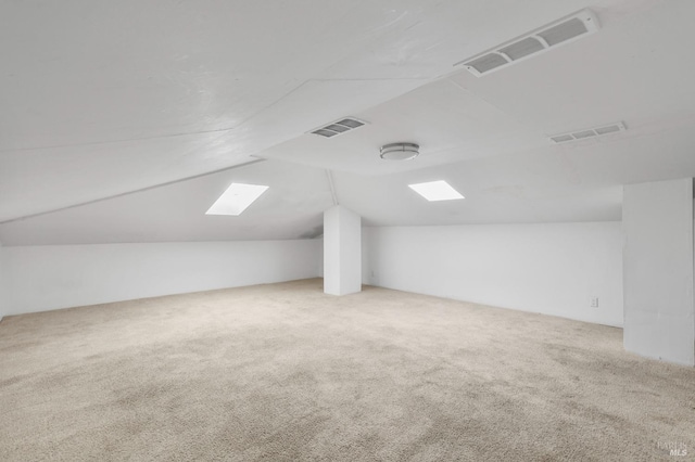 bonus room featuring lofted ceiling, visible vents, and carpet