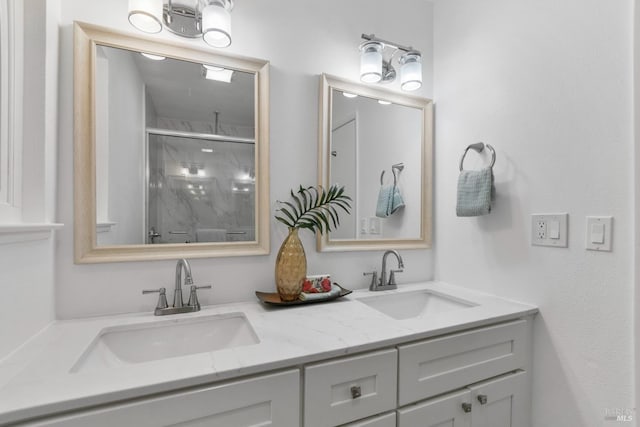 bathroom with a sink, double vanity, and a stall shower