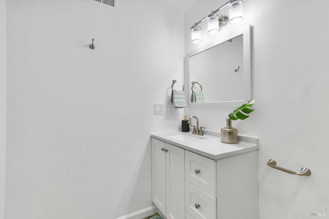 bathroom with baseboards, visible vents, and vanity