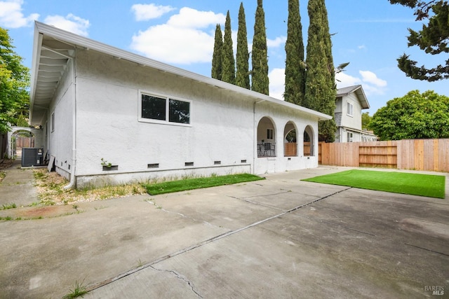 back of house featuring fence, crawl space, a patio area, and central air condition unit