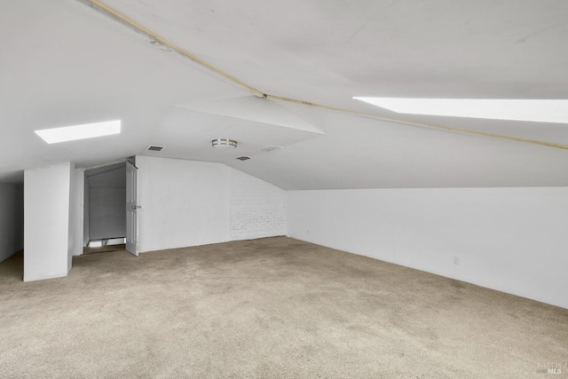 bonus room with carpet floors, vaulted ceiling, and visible vents
