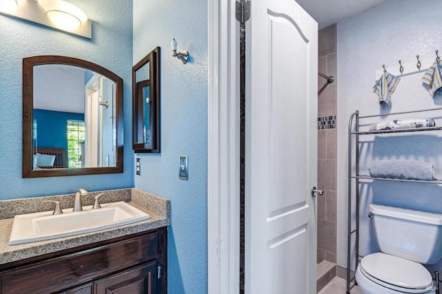 7350 Rasmussen Way, Rohnert Park, CA 94928 - bathroom with a tile shower, a textured wall, toilet, and vanity