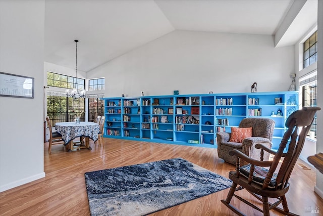 7350 Rasmussen Way, Rohnert Park, CA 94928 - living area with a wealth of natural light, wood finished floors, an inviting chandelier, and high vaulted ceiling