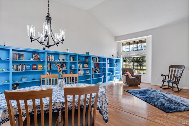 7350 Rasmussen Way, Rohnert Park, CA 94928 - dining space with baseboards, wood finished floors, high vaulted ceiling, and a notable chandelier