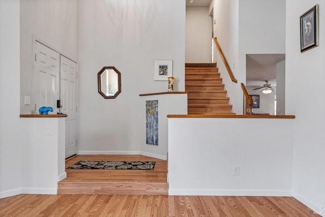 7350 Rasmussen Way, Rohnert Park, CA 94928 - foyer entrance with wood finished floors, stairs, ceiling fan, a towering ceiling, and baseboards