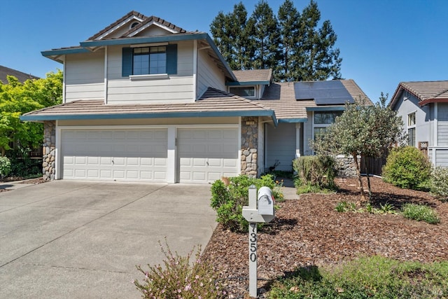 7350 Rasmussen Way, Rohnert Park, CA 94928 - traditional-style home with a tiled roof, solar panels, driveway, stone siding, and a garage