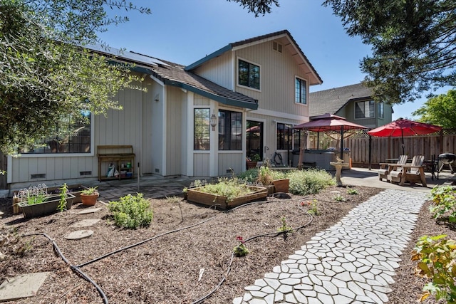 7350 Rasmussen Way, Rohnert Park, CA 94928 - rear view of house featuring fence, a hot tub, a vegetable garden, board and batten siding, and a patio