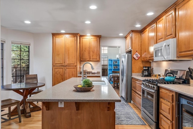 7350 Rasmussen Way, Rohnert Park, CA 94928 - kitchen with a sink, beverage cooler, light wood-style floors, stainless steel appliances, and light stone countertops