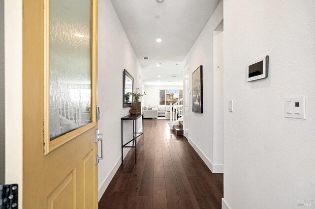 hall featuring baseboards, recessed lighting, and dark wood finished floors