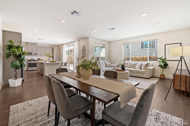 dining room with recessed lighting, wood finished floors, and visible vents
