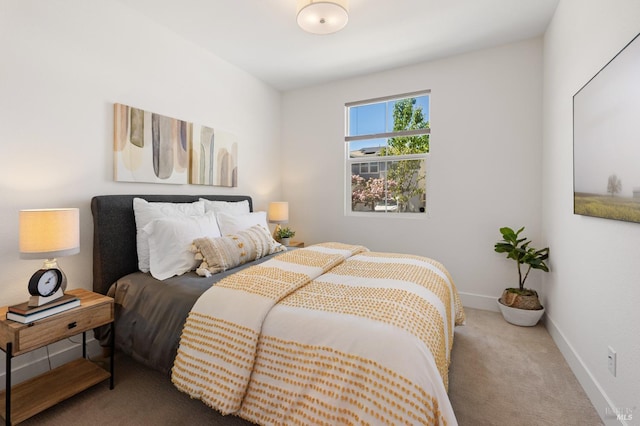 carpeted bedroom featuring baseboards