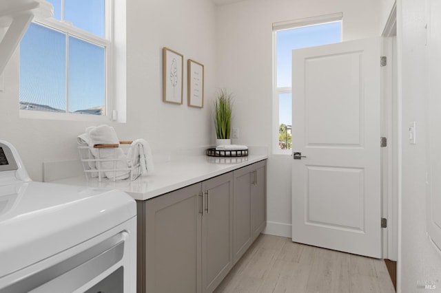 2428 Periwinkle Pl, Fairfield, CA 94533 - laundry area featuring plenty of natural light, cabinet space, and light wood-type flooring