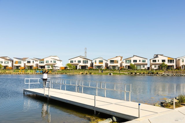 dock area featuring a residential view and a water view