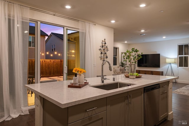 kitchen featuring open floor plan, stainless steel dishwasher, a sink, and dark wood-style flooring