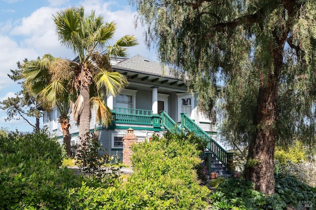 view of front of property with stairs and covered porch