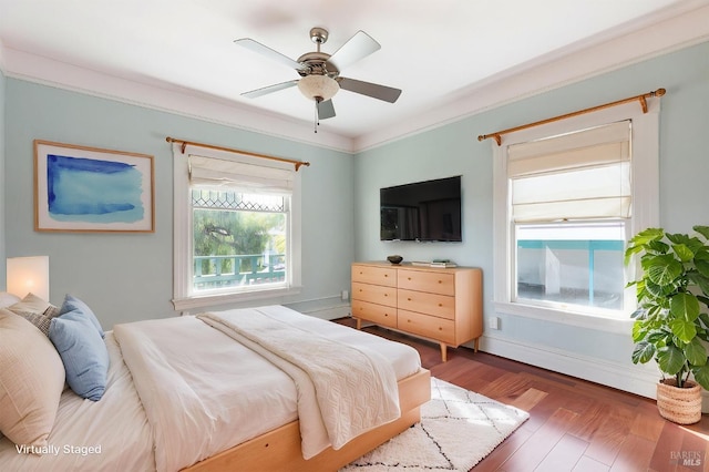 bedroom featuring wood finished floors, a ceiling fan, and baseboards
