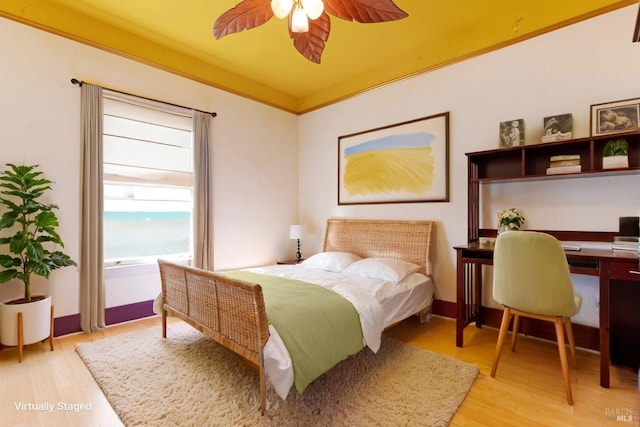 bedroom with a ceiling fan and light wood-style floors