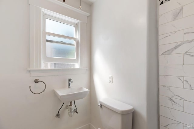 bathroom with toilet and a sink