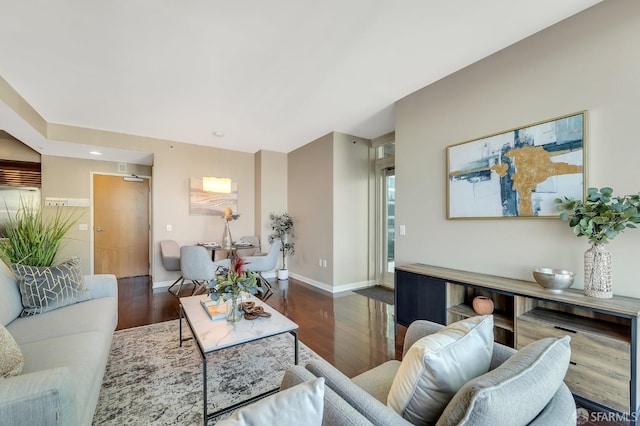 living room featuring wood finished floors and baseboards