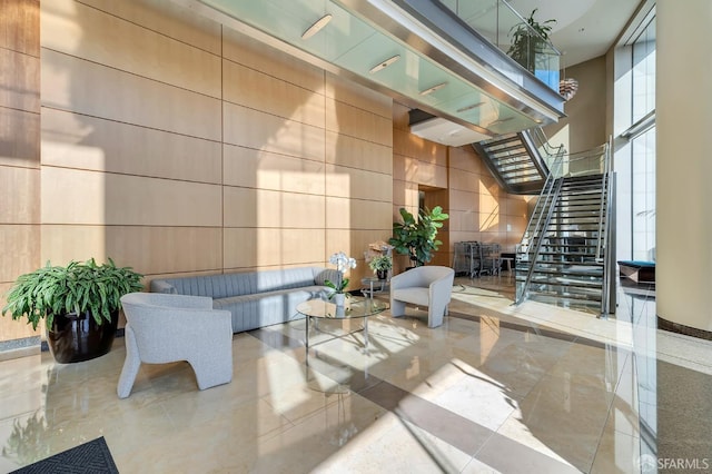 building lobby featuring stairs and a towering ceiling