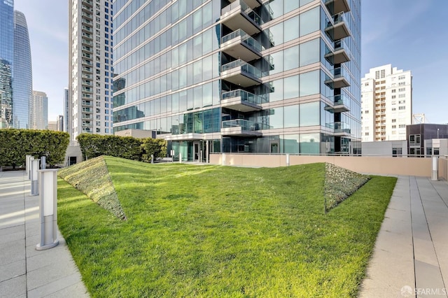 view of home's community featuring a view of city and a lawn