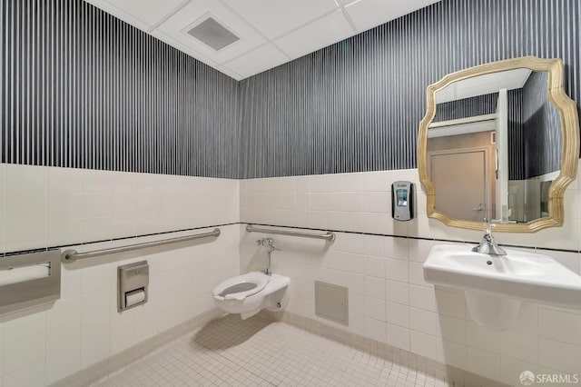 half bath with tile walls, tile patterned floors, and toilet