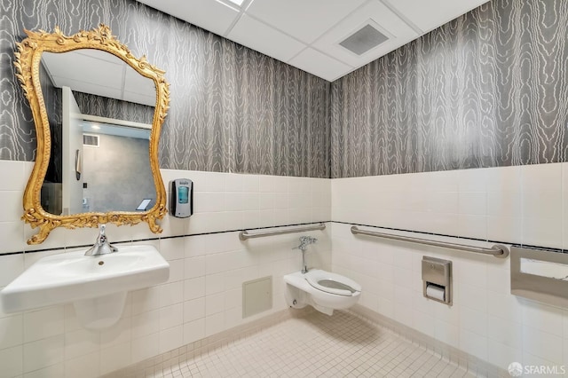 bathroom with tile walls, tile patterned floors, and toilet
